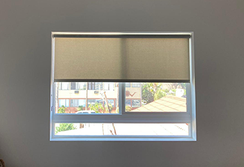 Custom roller shades installed on living room windows, enhancing the ambiance of Doris's home in Los Gatos.